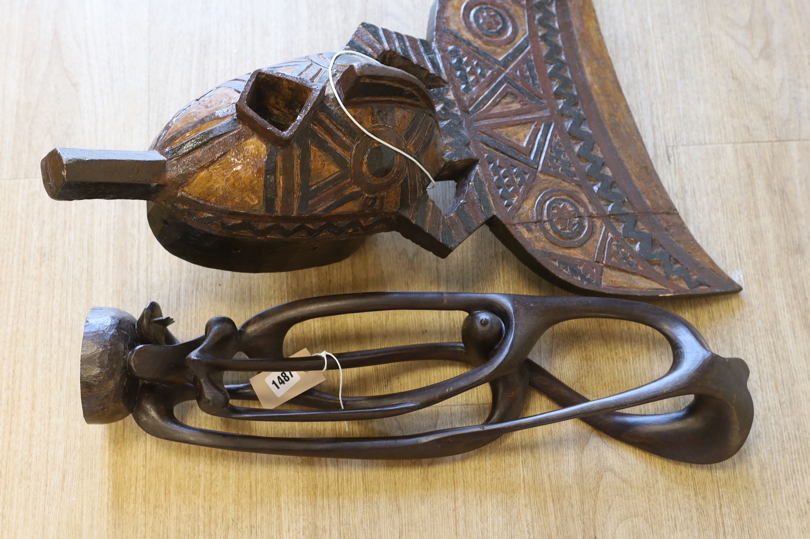 An African carved wood mask and a similar sculpture, 61cm high